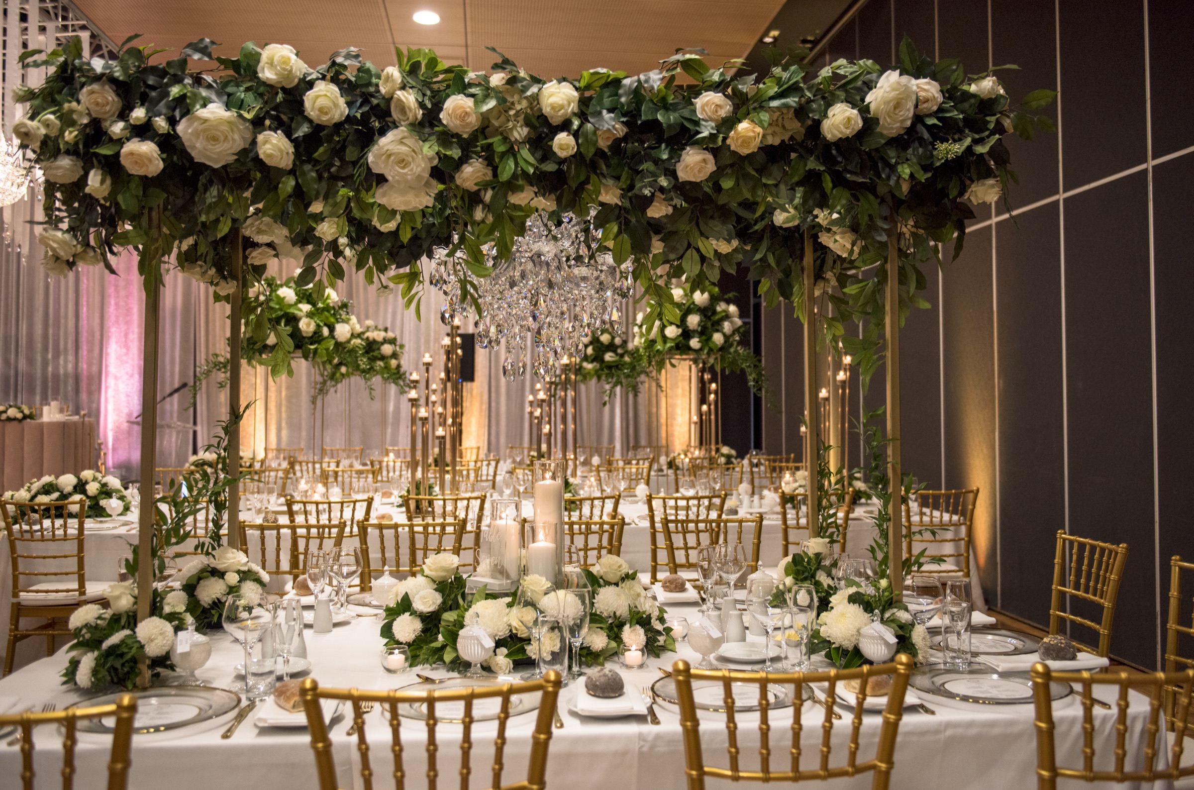 Heritage Hall set for a wedding reception with long tables, flowers and candlelight