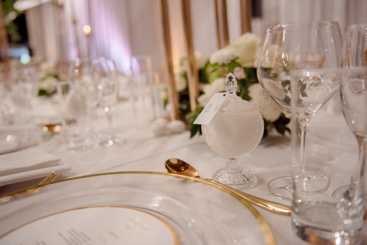 Place setting with gold cutlery and glassware in Heritage Hall